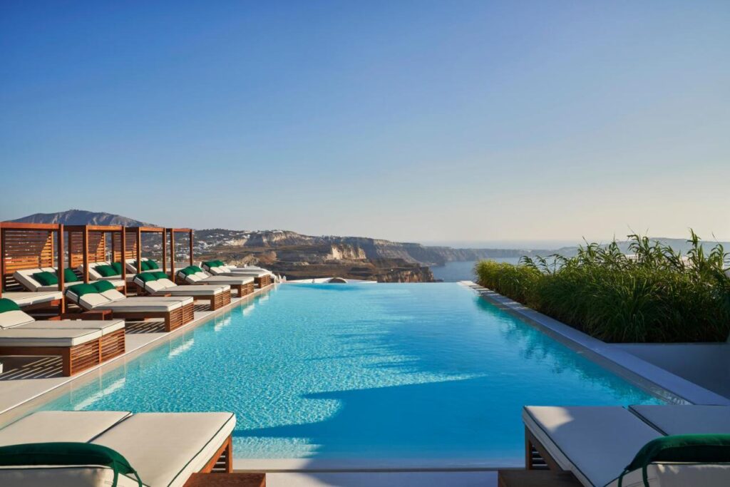 Open outdoor infinity swimming pool with garden views in Fira at Katikies Garden Santorini